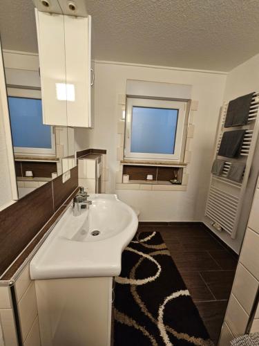 a bathroom with a white sink and a window at Ferienwohnung Medina in Bad Wildungen