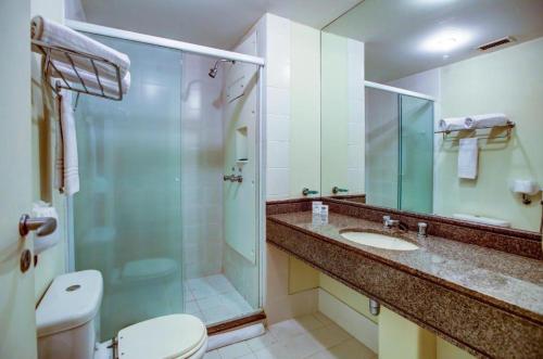 a bathroom with a shower and a toilet and a sink at Flat Nobile Congonhas in Sao Paulo