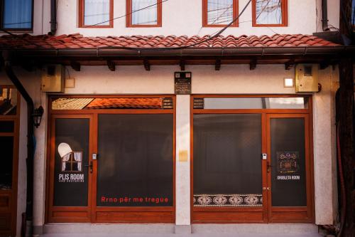 a store front with glass doors with a sign on it at Xhubleta Room - Old Bazaar in Peje