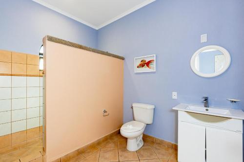 a bathroom with a toilet and a sink at Sunrise 2 - 3 Bedroom Condo At Tamarindo in Tamarindo