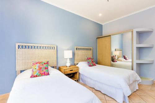 a bedroom with two beds and a mirror at Sunrise 2 - 3 Bedroom Condo At Tamarindo in Tamarindo