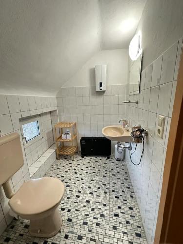 a bathroom with a toilet and a sink at Holiday Apartment Adenau in Adenau