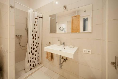 een witte badkamer met een wastafel en een douche bij Anett's downtown apartment in Boedapest