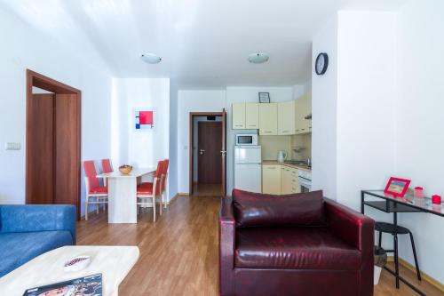 a living room with a couch and a table at Todorka Apartments in Bansko in Bansko