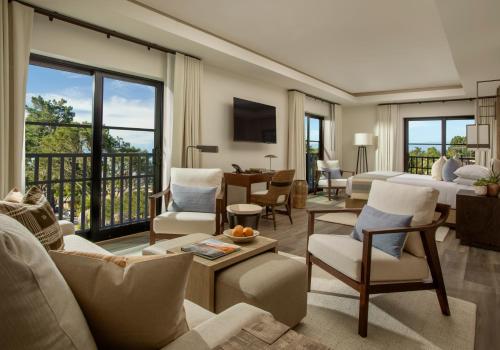 a bedroom with a living room with a bed and a living room at Stilwell Hotel in Carmel