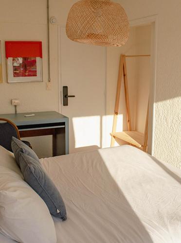 a bedroom with a bed and a table and a lamp at ZAG Coliving Punta del este in Punta del Este