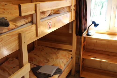 a room with wooden bunk beds in a cabin at Cottage Tatry so saunou in Tatranska Strba