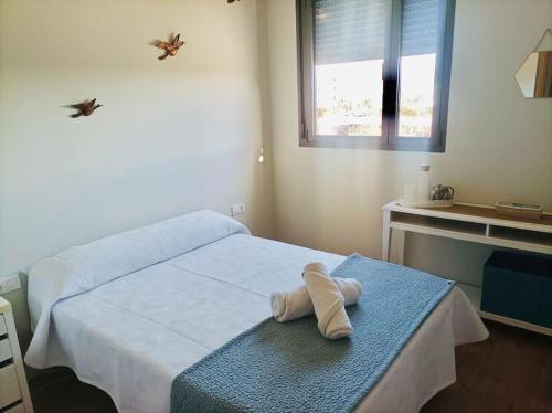 a bedroom with a bed with a towel on it at Habitación con baño privado para una sola persona No se renta apartamento completo in Palma de Mallorca