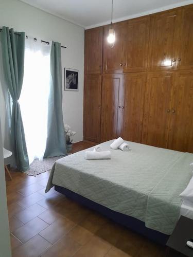 a bedroom with a bed with two towels on it at Andros Escape Chora in Andros