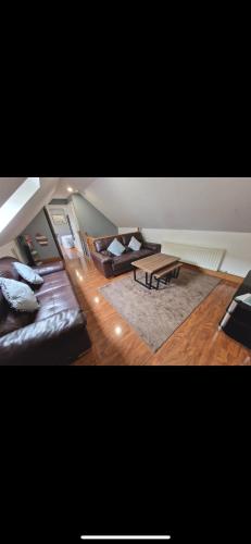 a living room with a couch and a table at Woodland lodge, apartment in Derry Londonderry