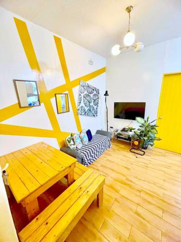 a living room with a wooden table and a couch at SEAWIND CONDOMINIUM RENTALS by AGL in Davao City