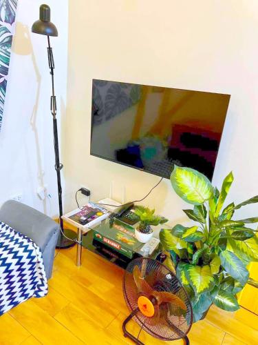 a living room with a table with a fan and plants at SEAWIND CONDOMINIUM RENTALS by AGL in Davao City