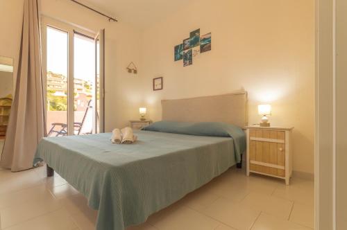 a bedroom with a bed with two towels on it at Casa Michela in Palau