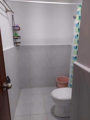 a bathroom with a toilet and a shower curtain at Saekyung 956 Condominium near SM seaside in Lo-oc