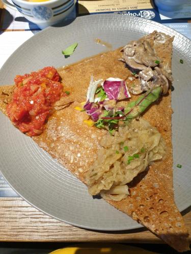 a white plate with two slices of food on it at Maison de vacances à Sarzeau à 5 min de la plage à pieds in Sarzeau