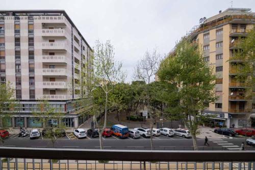 a parking lot with cars parked in front of a building at B&B Il Sorriso in Bari