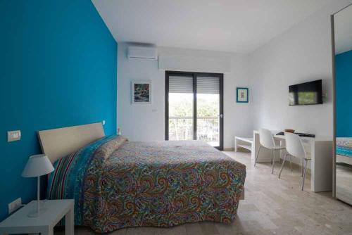a bedroom with a bed and a table and chairs at B&B Il Sorriso in Bari
