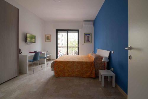 a bedroom with a bed and a blue wall at B&B Il Sorriso in Bari