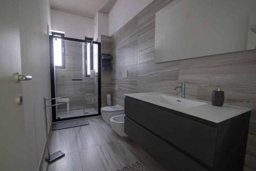 a bathroom with a sink and a toilet and a shower at B&B Il Sorriso in Bari