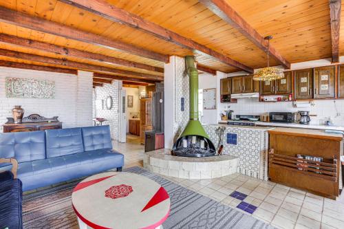a living room with a blue couch and a fireplace at Rosarito Beach Home in Las Gaviotas with Ocean Views in Raulis