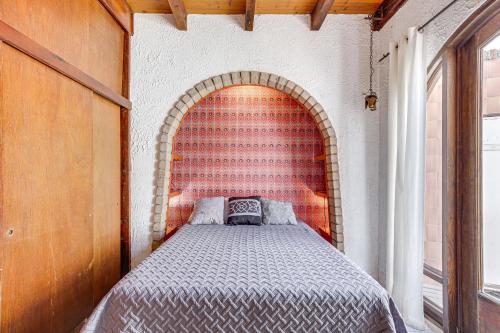 a bedroom with a bed in a brick wall at Rosarito Beach Home in Las Gaviotas with Ocean Views in Raulis