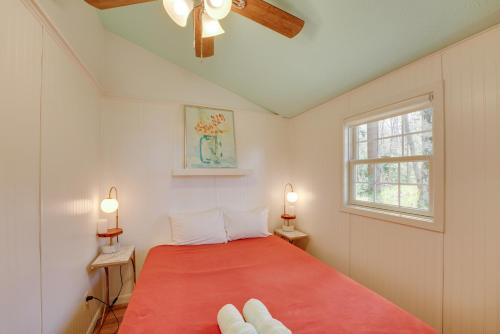 a bedroom with a red bed and a window at Beachfront Lake Michigan Cottage with Fire Pit and Deck in Muskegon