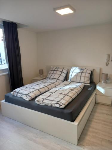 ein Bett mit zwei Kissen auf einem Zimmer in der Unterkunft Ferienwohnung Bremer Straße in Eschwege