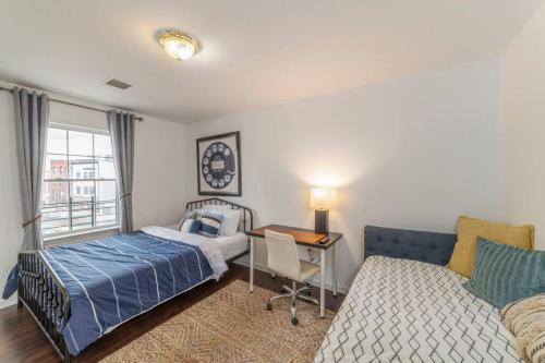 um quarto com uma cama, uma secretária e uma janela em Spacious 3B Oasis near Manhattan - 28 mins to NYC em Jersey City