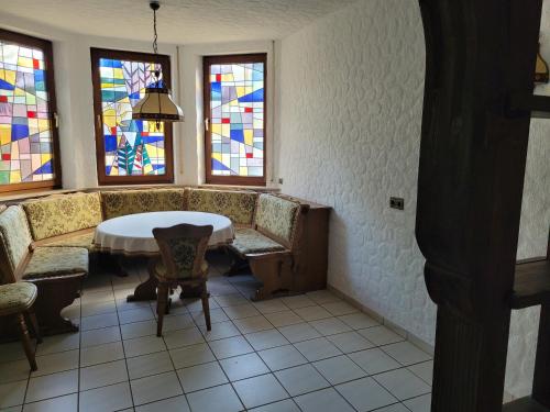 a room with a table and stained glass windows at Am Zimmerkopf in Hermersberg