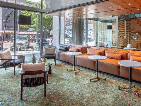 a living room with a couch and tables and windows at Luxury 1Bedroom 1Bath Pearl District in Portland