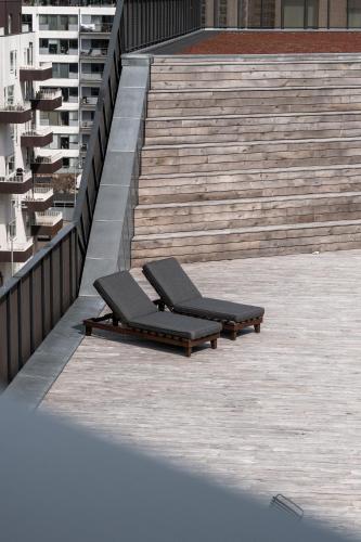 two lounge chairs sitting on a set of stairs at The Pier apartments by Daniel&Jacob's in Copenhagen