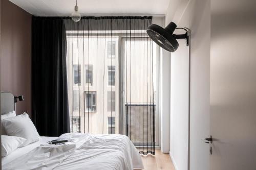 a bedroom with a bed and a large window at The Pier apartments by Daniel&Jacob's in Copenhagen