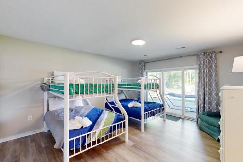 two bunk beds in a room with a window at Secluded Serenity in Bumpass