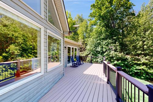 a porch of a house with blue chairs on it at Secluded Serenity in Bumpass