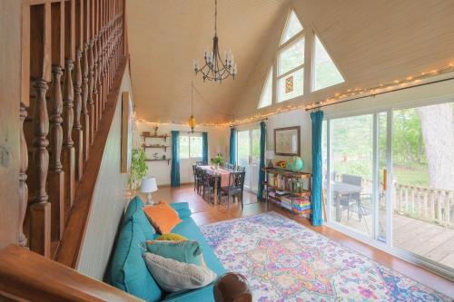 a living room with a blue couch and a dining room at Ancient Oak Sanctuary Rural getaway, walking paths in Grand Junction