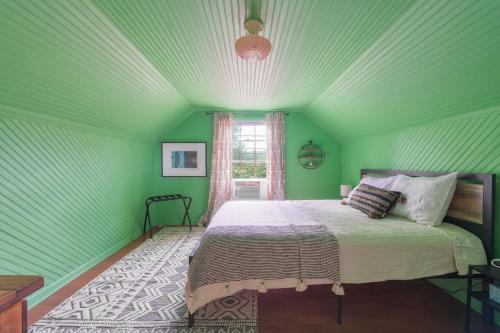 a green bedroom with a bed in a room at Ancient Oak Sanctuary Rural getaway, walking paths in Grand Junction
