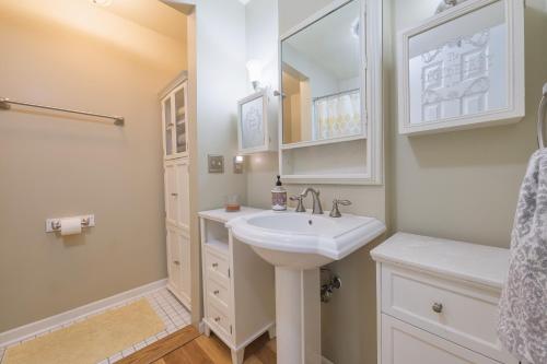 a white bathroom with a sink and a mirror at Ancient Oak Sanctuary Rural getaway, walking paths in Grand Junction