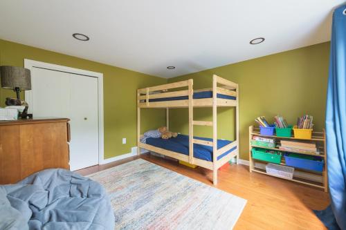 a bedroom with green walls and bunk beds at Ancient Oak Sanctuary Rural getaway, walking paths in Grand Junction
