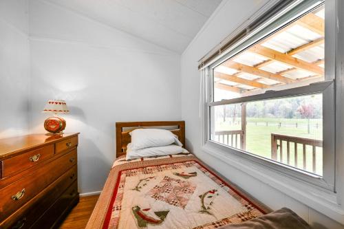 a bedroom with a bed and a large window at Cozy Huntingdon Escape 19 Mi to Penn State Univ! in Huntingdon