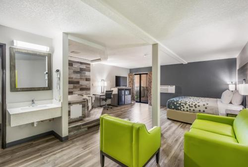 a hotel room with a bed and a bathroom at Sonesta Essential Des Moines in Des Moines