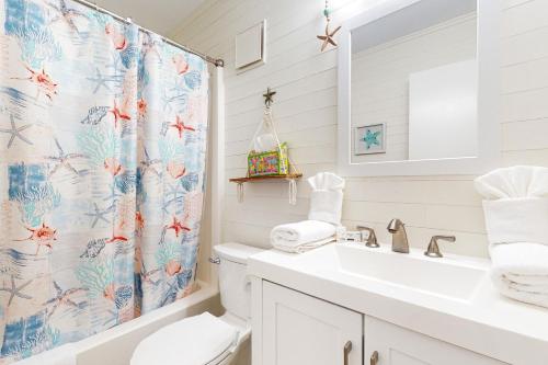 a bathroom with a toilet and a shower curtain at Island Beach & Racquet Club H115 in Atlantic Beach