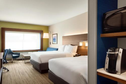 a hotel room with two beds and a television at Holiday Inn Express & Suites - West Des Moines - Jordan Creek, an IHG Hotel in West Des Moines