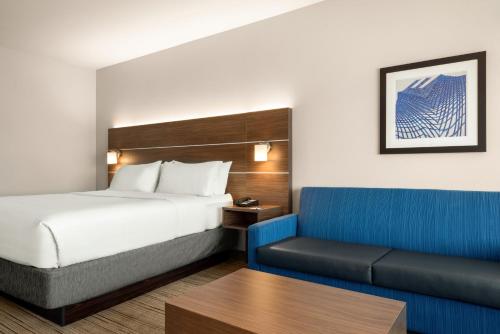 a hotel room with a bed and a couch at Holiday Inn Express & Suites - West Des Moines - Jordan Creek by IHG in West Des Moines