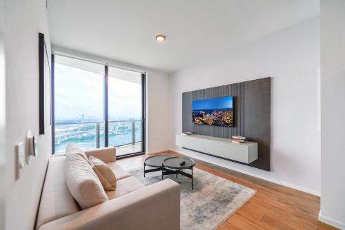a living room with a couch and a tv at Apartment Offering Direct Bay Views in Miami