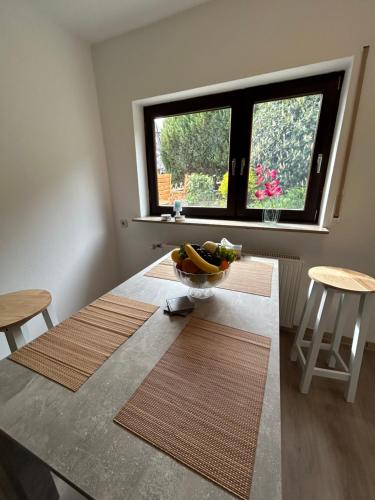 a kitchen with a table with a bowl of fruit on it at Ferienwohnung Mittenaar in Mittenaar