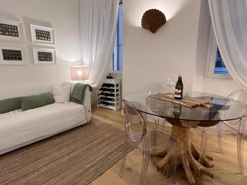 a living room with a glass table and a couch at Camogli - "Il Nido" - Liguria Holidays in Camogli