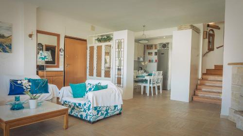 a living room with two chairs and a table at Zeus Sea View Villa with Private Pool, Afytos in Afitos
