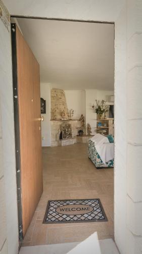 an open door to a bedroom with a bed in a room at Zeus Sea View Villa with Private Pool, Afytos in Afitos