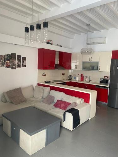 a living room with a white couch and red cabinets at Beautiful apartment in Mykonos town ! in Mýkonos City