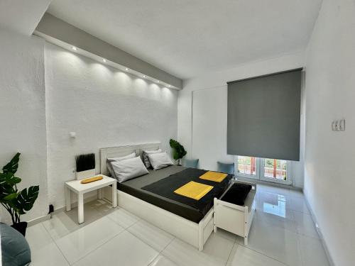 a bedroom with a bed and a table and a window at Four Seasons - The White Queen House in Kriopigi
